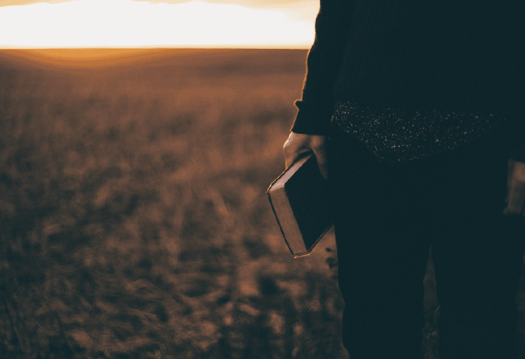 Man holding a Bible during Mens Fellowship at Wellington Presbyterian Church.