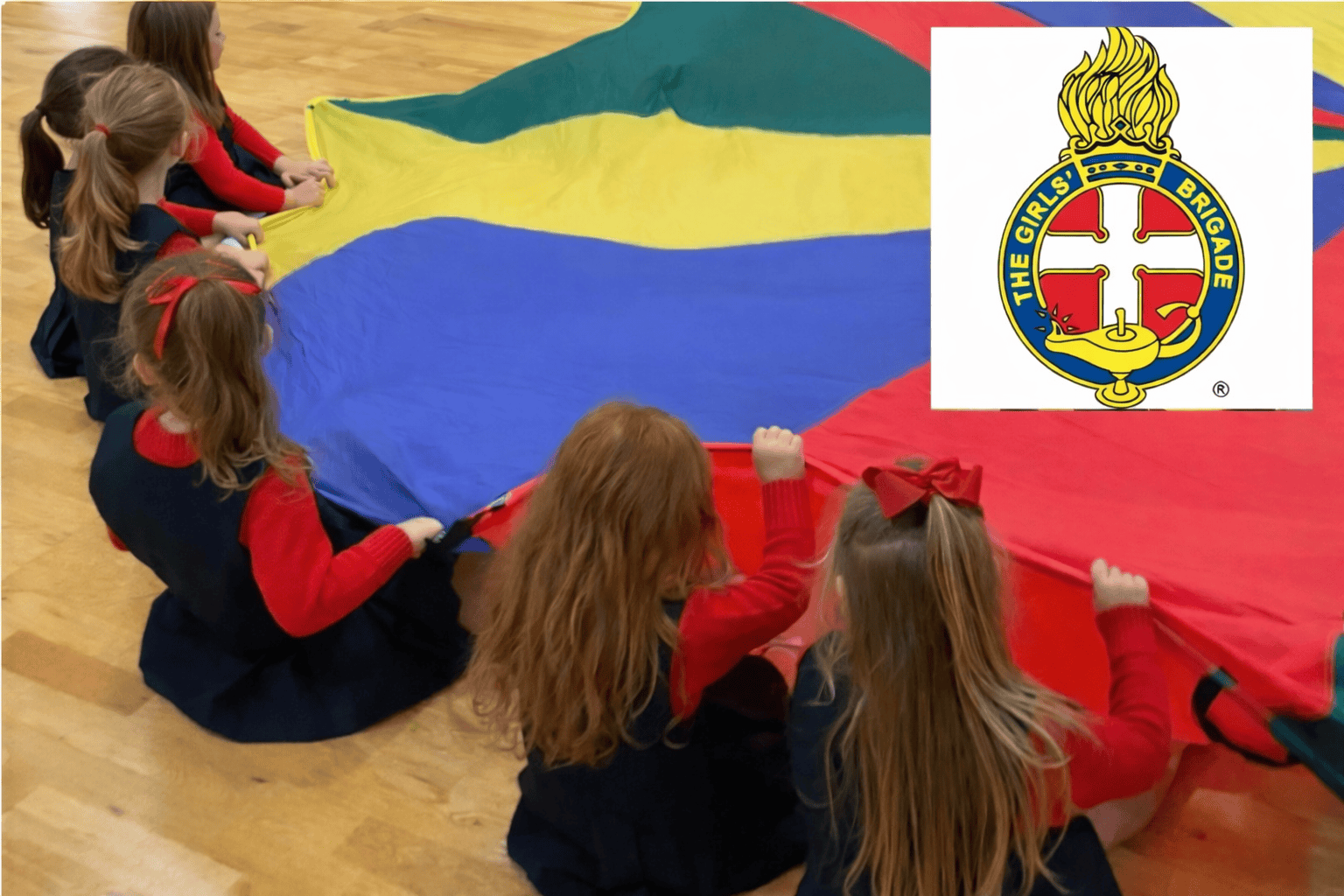 Girls' Brigade children playing with parachute during church event.