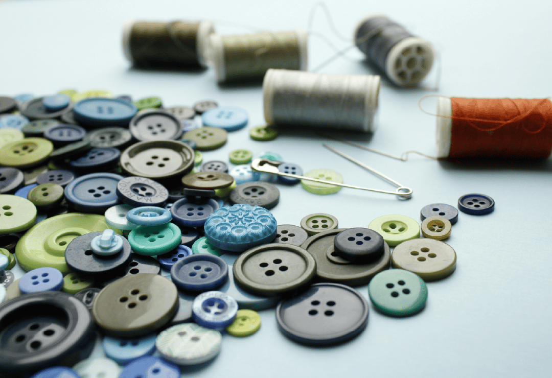 Assorted sewing buttons and threads for craft projects at Sew Crafty.