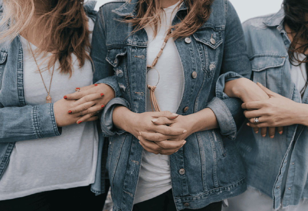 Women wearing denim jackets at Sew Crafty event.