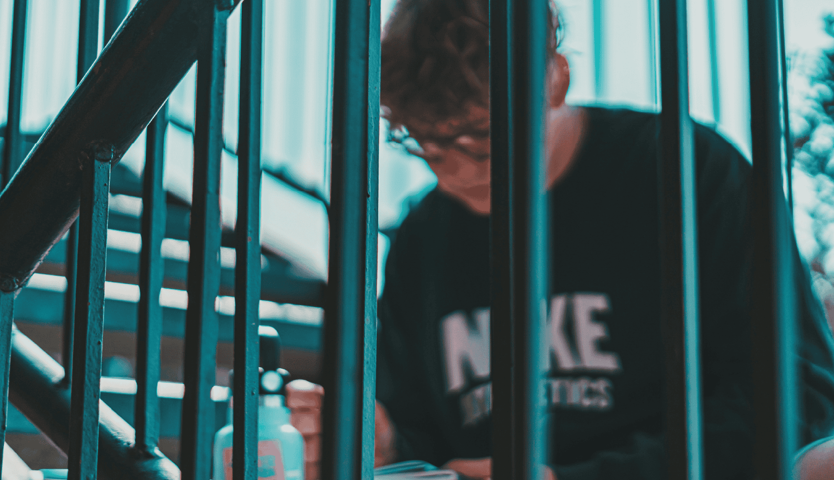 Child using hand sanitizer on church steps during community event.
